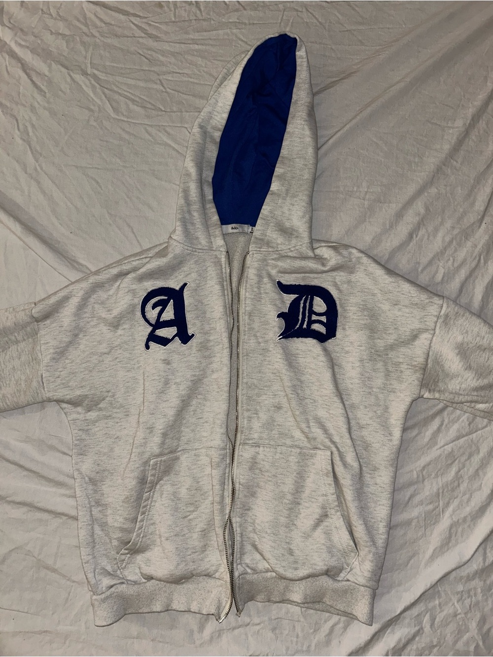 Adika Cream Zip Hoodie with Blue Hood Lining and Navy Lettering